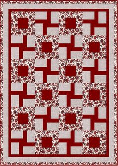 a red and white quilt with squares in the shape of squares on top of each other