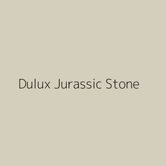 the words dulux jurasic stone are in black and white on a beige background