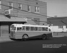 an old bus parked in front of a building