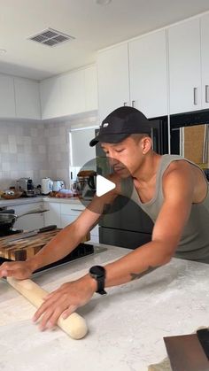 a man rolling dough on top of a counter