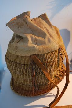 This magnificent hand woven carry-all or large purse has a leather top, with drawstring closure.  The body of the bag is woven in an intricate basket weave, and the handles, straps, and all acourtrements are made from leather.  I believe it is from South America, as I have had Indonesian woven bags and they have not had the proliferation of leather bindings.  Please examine the photographs carefully.  It measures approximately 18 inches high, 13 inches wide and 12 inches deep.  For the initial p Leather Bucket Bag With Braided Handles In Basket Shape, Natural Intrecciato Weave Bucket Bag For Travel, Natural Leather Basket-shaped Bucket Bag, Natural Leather Basket Bucket Bag, Woven Leather Basket Shoulder Bag, Weaving Bucket Bag For Travel, Travel Straw Bag With Weaving Details, Woven Leather Basket Straw Bag, Woven Leather Basket Bag