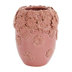 a pink ceramic vase with flowers on it's sides and an intricately carved design