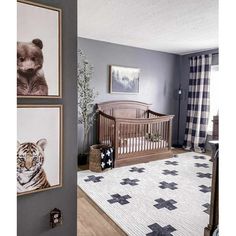 a baby's room with grey walls and pictures on the wall