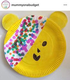 a paper plate shaped like a bear with sprinkles on it's face