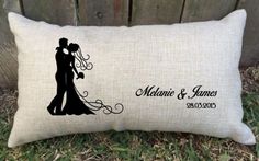 a pillow with a silhouette of a bride and groom on it