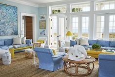 a living room filled with blue and yellow furniture