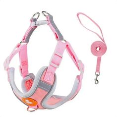 a pink and grey dog harness with leash