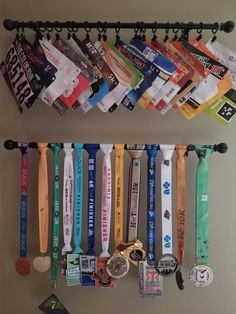 there are many medals hanging on the wall next to each other and one has a medal holder