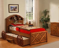 a wooden bed sitting on top of a hard wood floor next to a dresser and mirror