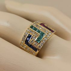 18 Carat (750) solid gold Greek key design ( Meander ) ring with Diamonds ,Emeralds ,Rubies and Sapphires The ring has 48 pieces Brilliant cut diamonds The total weight of the diamonds is 0.70 ct. color grade of the diamonds is ( G ) and clarity grade VS 1 - VVS 2 (Natural diamonds not man made ) and 24 pc. square cut precious stones Emeralds Rubies and Sapphires total weight 1.84 ct. The weight of the ring is 12,40 grams 18 carat (750) It's made in Greece in our workshop in Athens A beautiful G Emerald Cut Multi-stone Sapphire Ring With Diamonds, Yellow Gold Multi-stone Emerald Cut Sapphire Ring, Yellow Gold Ruby Ring With Channel Set Diamonds, Ruby Ring With Channel Set Diamonds In Yellow Gold, Emerald Cut Emerald Ring With Multi-stone Diamond, Emerald Cut Multi-stone Sapphire Ring In Yellow Gold, Emerald-cut Multi-stone Diamond Emerald Ring, Gold Multi-stone Emerald Cut Sapphire Ring, Yellow Gold Multi-stone Emerald Cut Diamond Ring