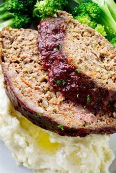 meatloaf with cranberry sauce on top of mashed potatoes and broccoli