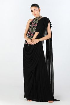 Black pre-draped saree with embellished waistband. Comes with floral pattern drape and one shoulder blouse.
Components: 3
Type Of Work: Floral
Neckline: One Shoulder
Sleeve Type: Asymmetric
Fabric: Crepe, Georgette
Color: Black
Other Details: 
Asymmetric silhouette
Occasion: Sangeet,Cocktail - Aza Fashions Black Pre-draped Saree With Dupatta For Reception, Black Pre-draped Saree With Zari Work, Evening Pre-draped Saree For Navratri, Evening Choli With Sheer Dupatta And Draped Design, Traditional Draped Saree For Evening, Evening Draped Choli With Sheer Dupatta, Traditional Draped Evening Saree, Evening Pre-draped Saree With Dupatta For Navratri, Black Georgette Pre-draped Saree For Reception