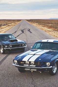 two classic muscle cars are parked on the road