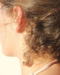 the back of a woman's head with hair in it