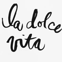 the words la dolce vita written in cursive black ink on a white background