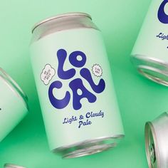 three cans of low carb light and cloudy pale on a green background