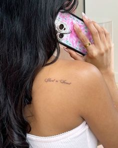 a woman holding a cell phone up to her ear while wearing a pink flowered dress