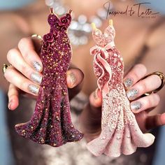 two handmade figurines in the shape of dresses