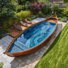 a wooden boat sitting on top of a lush green field next to a swimming pool