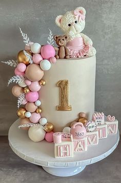 a birthday cake decorated with balloons and teddy bears