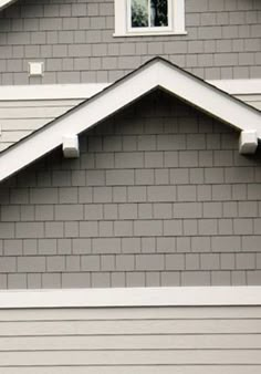 a gray house with white trim and windows