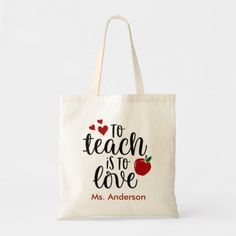 a tote bag with the words teach is love and an apple