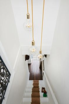 an overhead view of a staircase with chandeliers hanging from it's ceiling