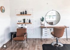 a hair salon with chairs, mirrors and shelves