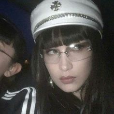 two young people wearing glasses and hats