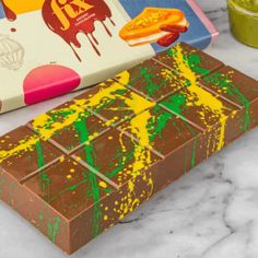 a chocolate bar with yellow and green paint on it