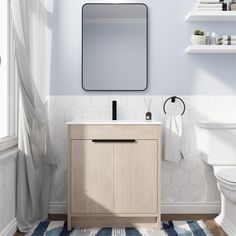 a bathroom with a sink, toilet and mirror