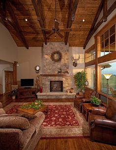 a living room with couches, chairs and a fireplace