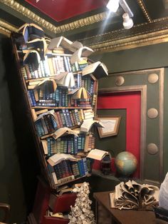 a bookshelf filled with lots of books next to a red door