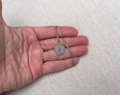 "This is a understated and elegant little boho disc pendant necklace. It is perfect for everyday wear and would go with just about anything. The disc measures 3/4\" long by 5/8\" wide and is made from allergy free plated silver. It hangs from a simple stainless steel necklace chain. I have matching earrings in my shop, if you would like the whole set. Here is the link https://etsy.me/2VZ551y Thanks for stopping by! Please take a moment and visit the rest of my Etsy shop. I have many more unique Bohemian Round Necklace For Everyday Wear, Bohemian Round Necklace For Everyday, Everyday Bohemian Round Necklace, Bohemian Everyday Round Necklace, Everyday Bohemian Charm Necklace With Round Pendant, Silver Necklace With Delicate Chain For Festivals, Bohemian Silver Charm Necklace With Delicate Chain, Bohemian Necklace With Delicate Chain And Round Pendant, Bohemian Charm Necklaces With Delicate Chain