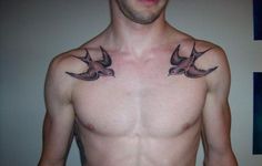 a shirtless man with three birds on his chest