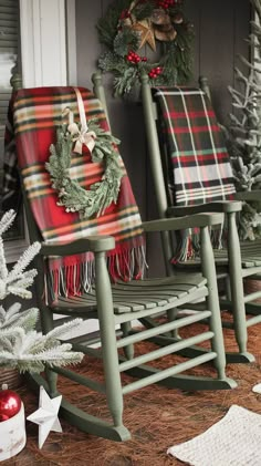 two rocking chairs decorated with christmas wreaths and plaid blankets