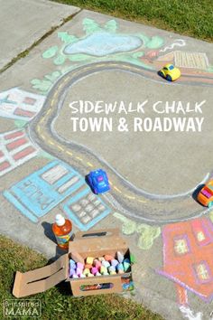 sidewalk chalk town and roadway with children's toys on the ground next to it