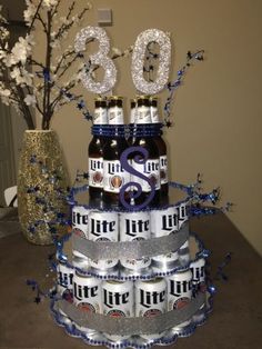 there is a cake made to look like a beer tower with bottles and numbers on it