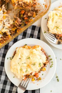 a white plate topped with mashed potatoes next to a casserole filled with meat