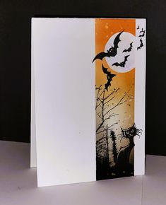 an orange and black halloween card with bats