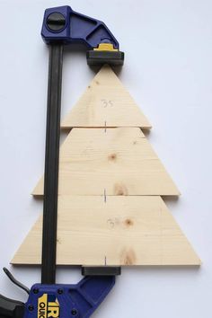 a wooden christmas tree with tools attached to it