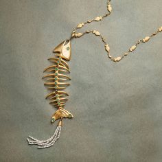 Introducing our exquisite Fish Bone Necklace, a truly remarkable piece of jewelry authentically designed with inspirations from various civilizations that thrived in Anatolia throughout history Fish is the animal form of thunder in Turkish mythology. It is a symbol of abundance, fertility, prosperity, happiness and reproduction. According to some legends in Anatolia, throwing fish into the water grants wishes as well as the ability to transform and do heroic deeds. Weight of fish necklace: 65 g Fish Bone Necklace, Gold Long Chain, Pisces Necklace, Pomegranate Earrings, Pomegranate Jewelry, Pomegranate Design, Fish Necklace, Bone Necklace, Punk Vintage