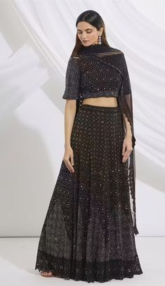 Black lehenga with embroidered motifs, paired with embroidered blouse and dupatta, featuring a boat neckline, elbow-length sleeves, cutwork detail, and side tassel tie-up. Elbow Length Sleeve, Cut Work