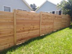 a wooden fence in front of a house