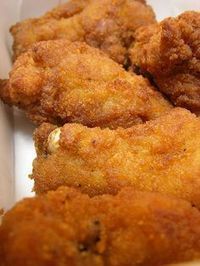 some fried food in a white container on a table