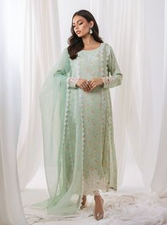 opt for elegant garden of ethereal beauty with our pastel green floral printed outfit, a masterpiece that embodies the essence of springtime elegance. The long shirt boasts with intricate cut work adorning the sleeves and hemline, The neckline is adorned with exquisite embroidery, reminiscent of blooming blossoms. Completing the ensemble with a matching organza dupatta, and pants the subtle detailing adds a touch of refinement. Shirt: Printed ShamosePants: Raw SilkDupatta: Organza Velvet Formal Dress, Silk Outfits, Zainab Chottani, Luxury Pret, Elegant Garden, Bloom Blossom, Special Occasion Outfits, Organza Dupatta, Pakistani Designers