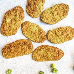 broccoli florets are arranged next to some breaded pastries on a towel