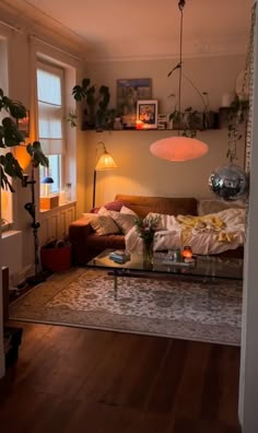 a living room filled with furniture and plants