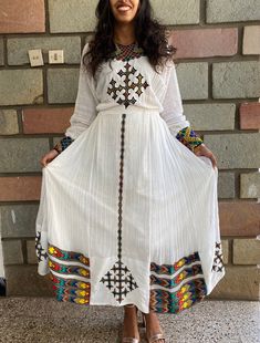 A hand embroidered and hand woven traditional Ethiopian dress. The cross on the trim line is also hand embroidered which makes it a unique from other dresses. The dress is made to order, please include your size when you place your order. Please include your phone number with your address. It's required on the shipping form. Eritrean Clothing, Eritrean Dress, Ethiopian Clothing, Ethiopian Traditional Dress, Ethiopian Dress, Habesha Kemis, Pastry Desserts, Traditional Fashion, Traditional Dress