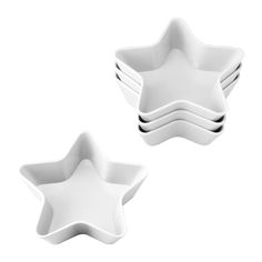 three white star shaped dishes sitting on top of each other